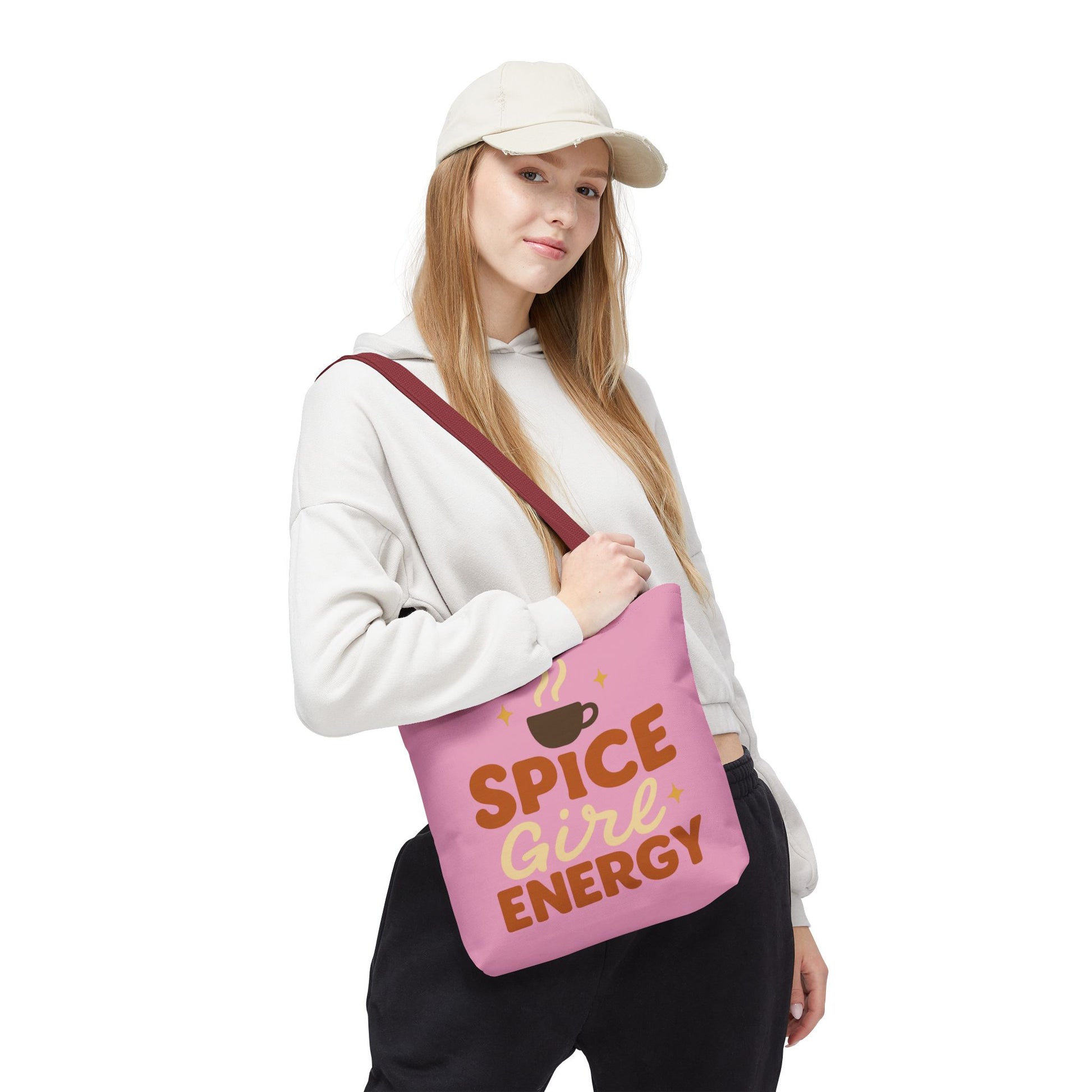 Woman carrying mauve “Spice Girl Energy” tote bag with red handles — trendy pink tote for cozy coffee runs and autumn outings.