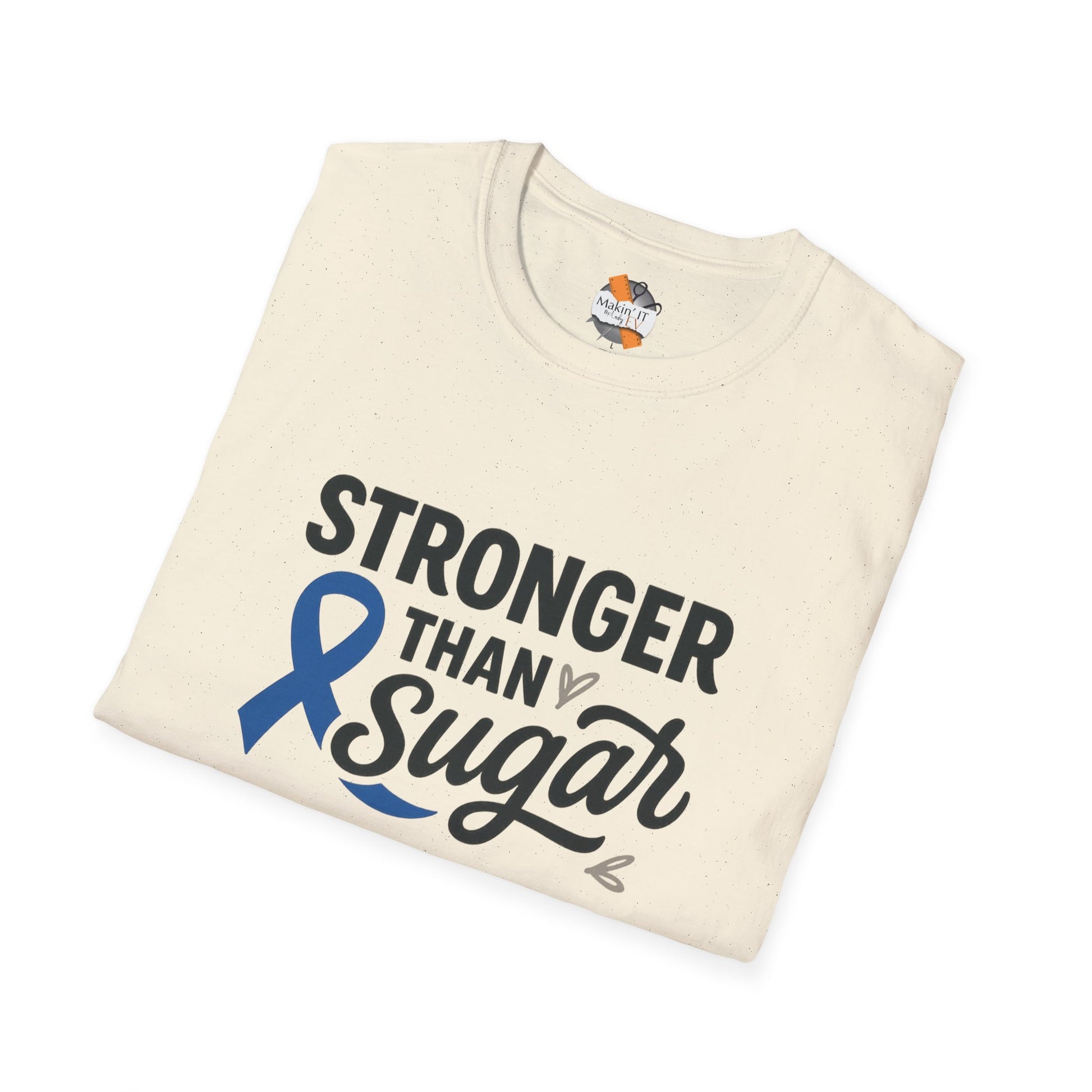 Folded Natural Stronger Than Sugar t-shirt — soft awareness tee with blue ribbon design promoting diabetes strength and hope.