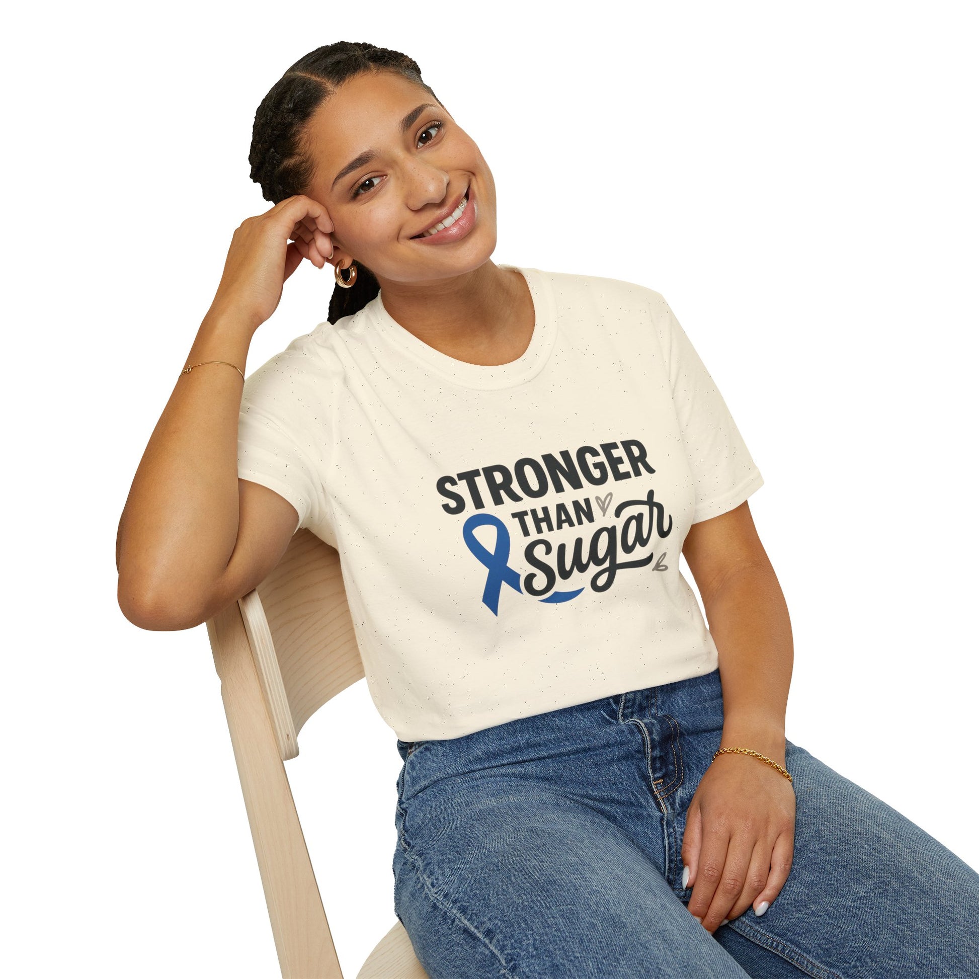 Smiling woman seated wearing Natural Stronger Than Sugar t-shirt — comfortable awareness apparel celebrating hope and health empowerment.