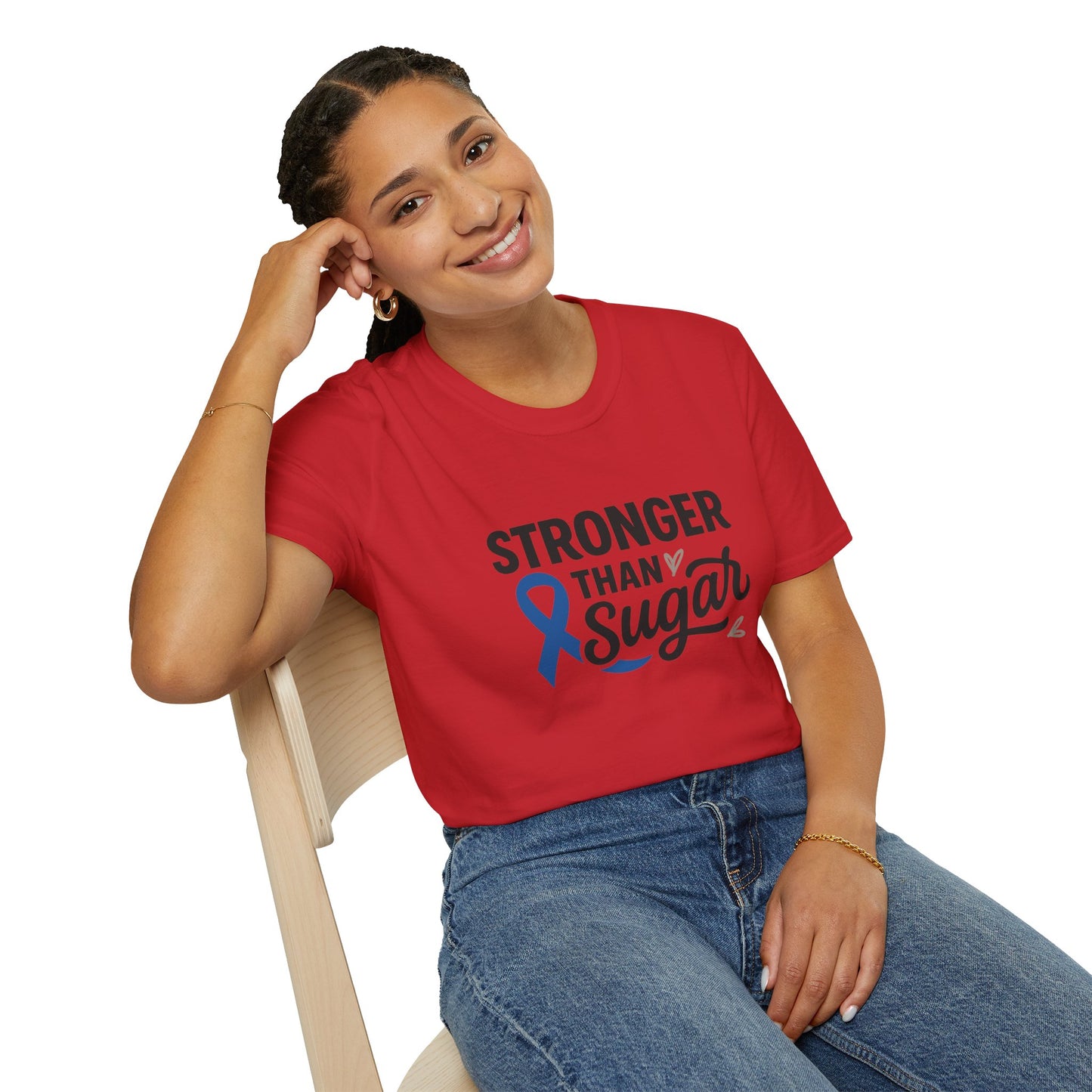 Smiling woman seated wearing red Stronger Than Sugar t-shirt — bright awareness apparel celebrating diabetes warriors and everyday strength.