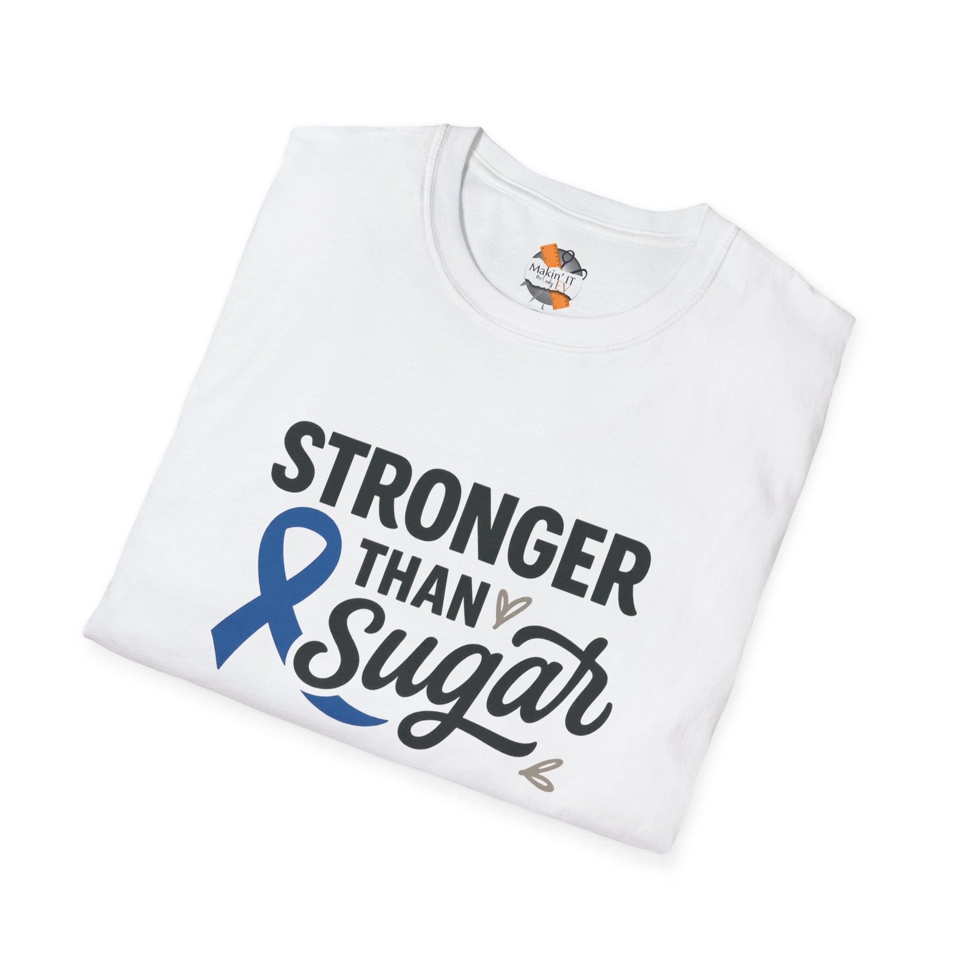 Folded White Stronger Than Sugar t-shirt — soft awareness tee with blue ribbon design promoting diabetes strength and hope.