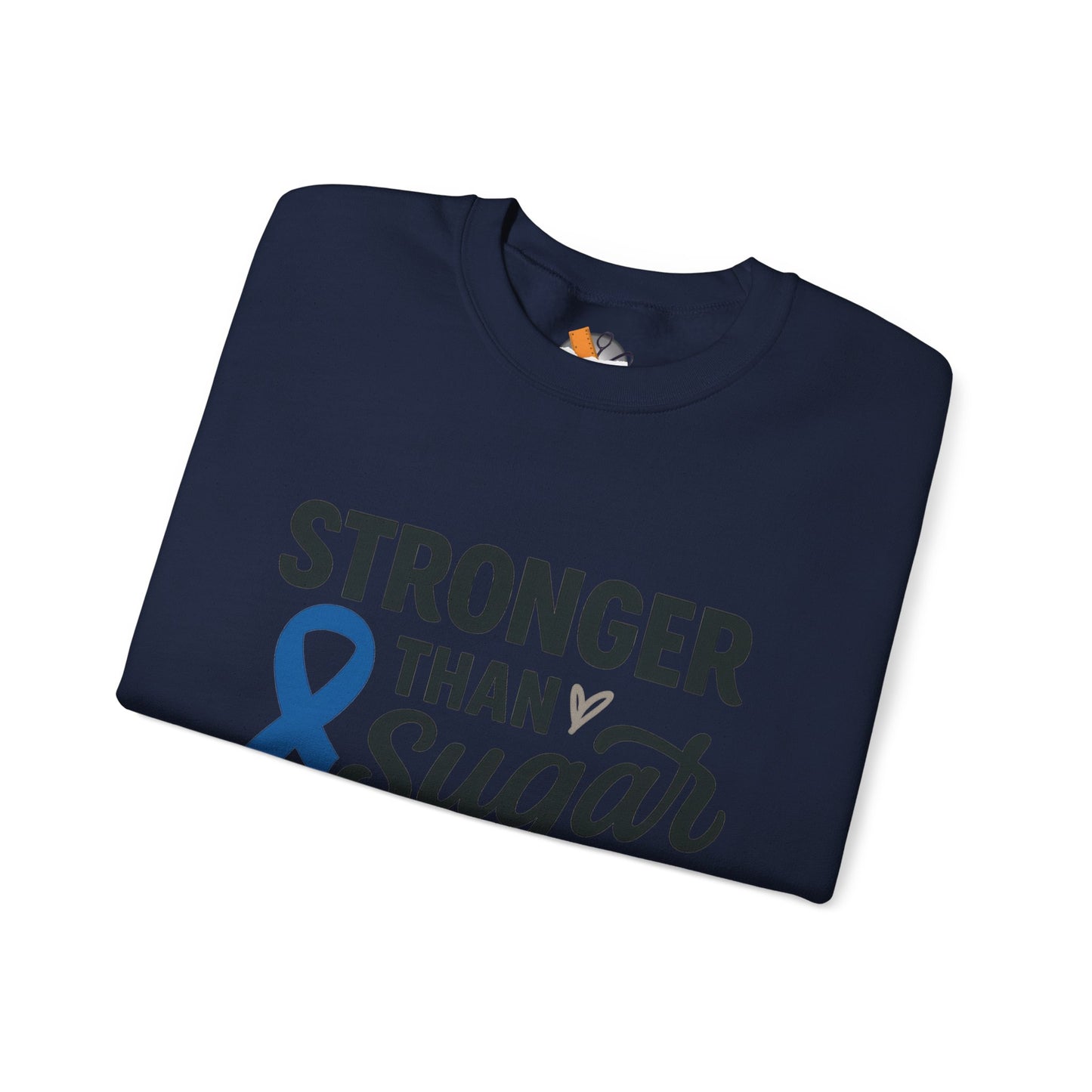 Folded navy blue Stronger Than Sugar sweatshirt with awareness ribbon — soft unisex crewneck for diabetes support and community advocacy.