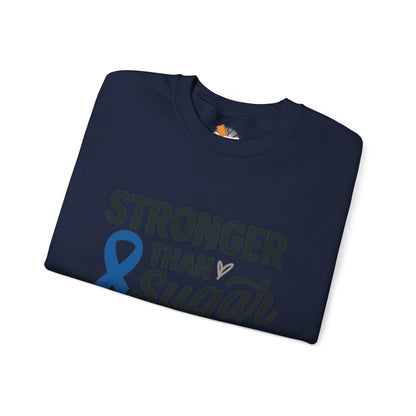 Folded navy blue Stronger Than Sugar sweatshirt with awareness ribbon — soft unisex crewneck for diabetes support and community advocacy.
