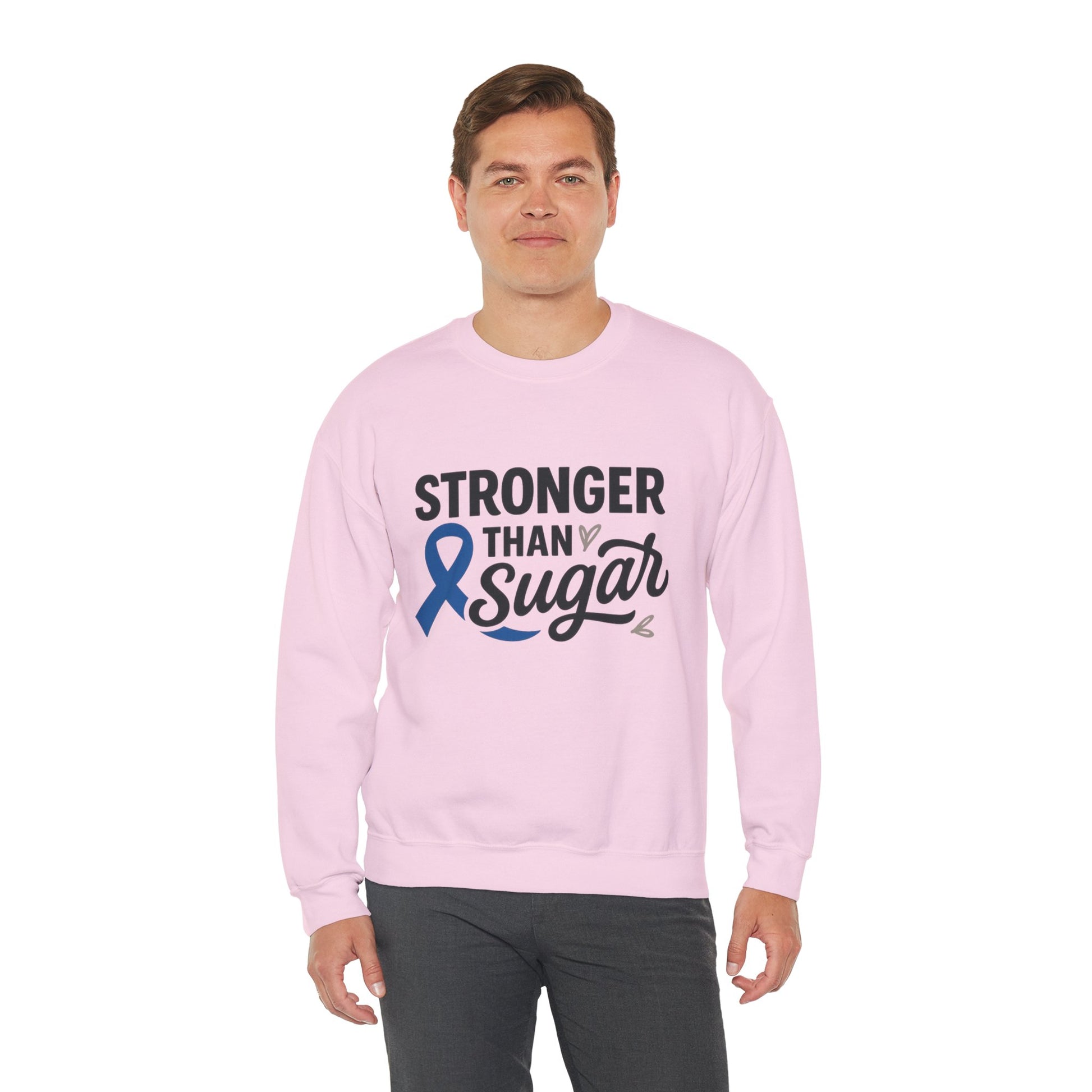 Male model wearing pink Stronger Than Sugar crewneck sweatshirt — unisex awareness sweater featuring blue diabetes ribbon and motivational design.