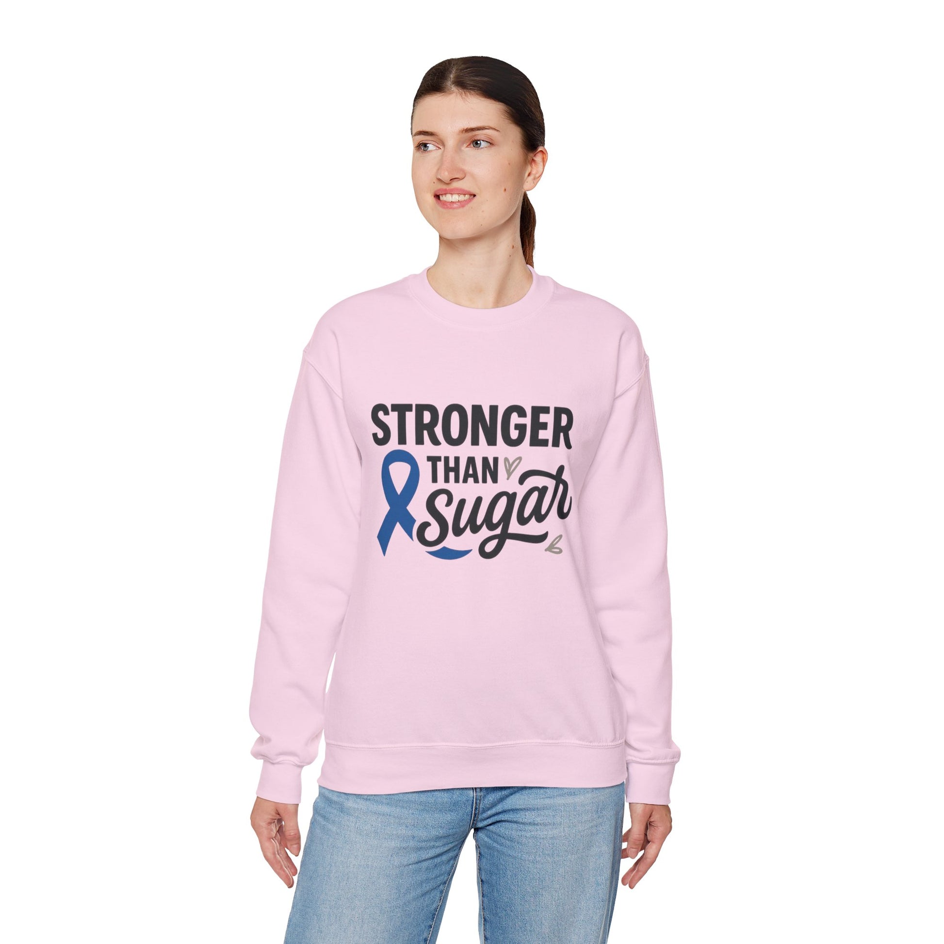 Female model in pink Stronger Than Sugar crewneck sweatshirt — soft unisex fleece with blue awareness ribbon symbolizing diabetes strength and unity.