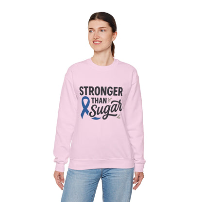 Female model in pink Stronger Than Sugar crewneck sweatshirt — soft unisex fleece with blue awareness ribbon symbolizing diabetes strength and unity.