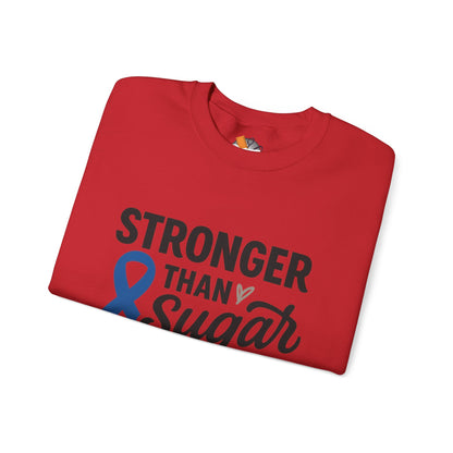 Folded red Stronger Than Sugar crewneck sweatshirt featuring bold awareness ribbon graphic — cozy unisex sweater for diabetes support and advocacy.