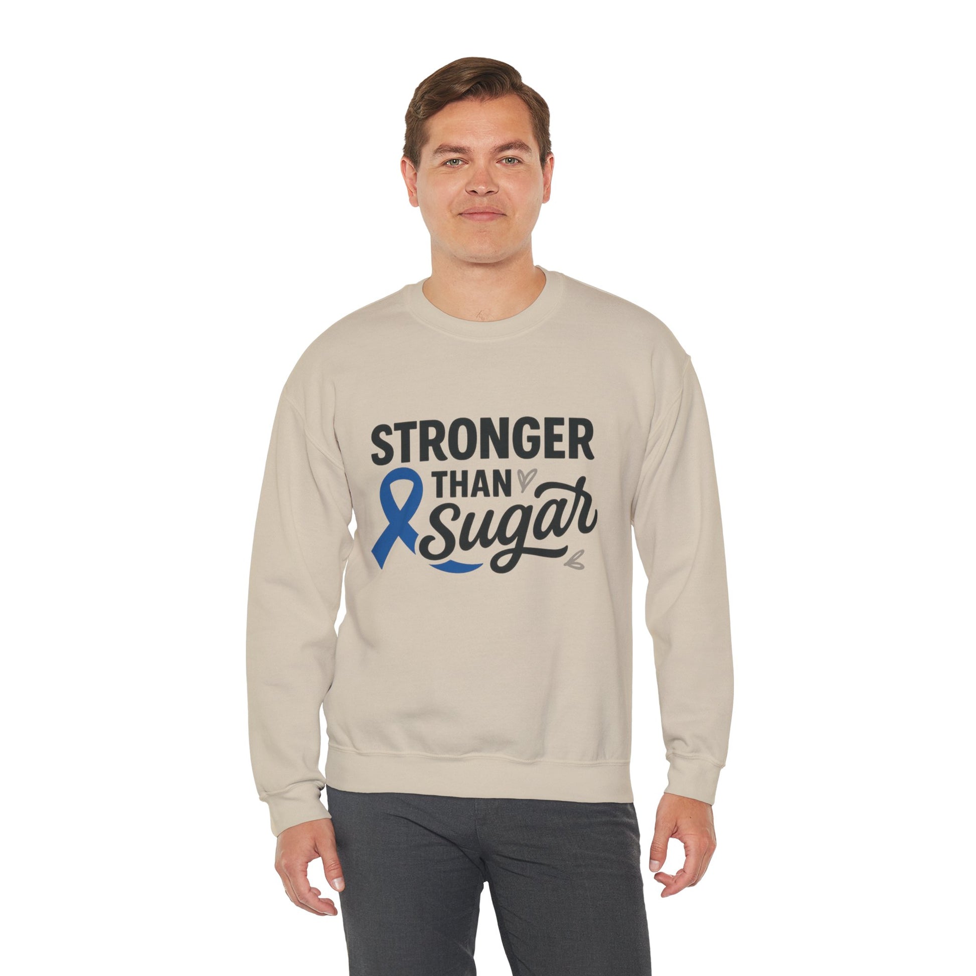 Male model wearing sand Stronger Than Sugar sweatshirt — unisex fleece crewneck for diabetes awareness and motivational advocacy wear.
