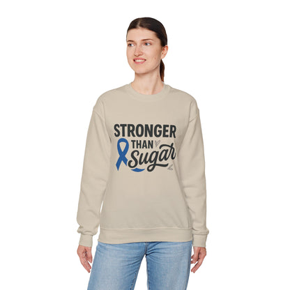 Female model in sand Stronger Than Sugar sweatshirt — cozy unisex awareness apparel with blue ribbon design symbolizing diabetes strength.