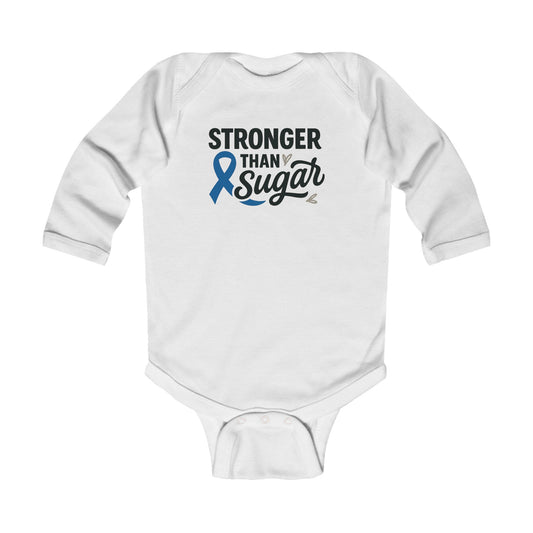 White Stronger Than Sugar infant long sleeve onesie featuring blue awareness ribbon and bold text — soft baby bodysuit promoting diabetes awareness and family strength.