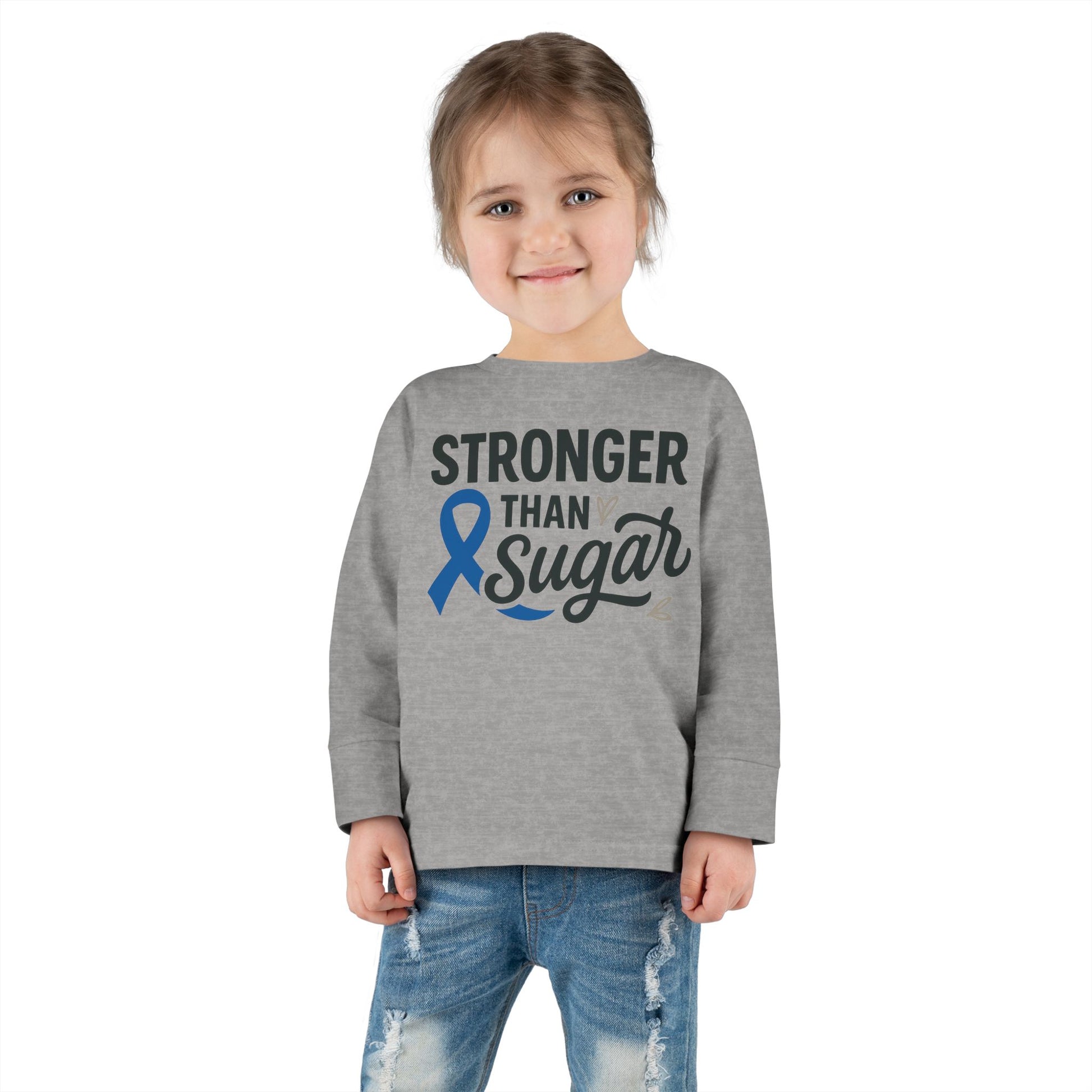Toddler girl in heather gray Stronger Than Sugar long sleeve shirt — unisex children’s tee supporting diabetes awareness and strength through positivity.