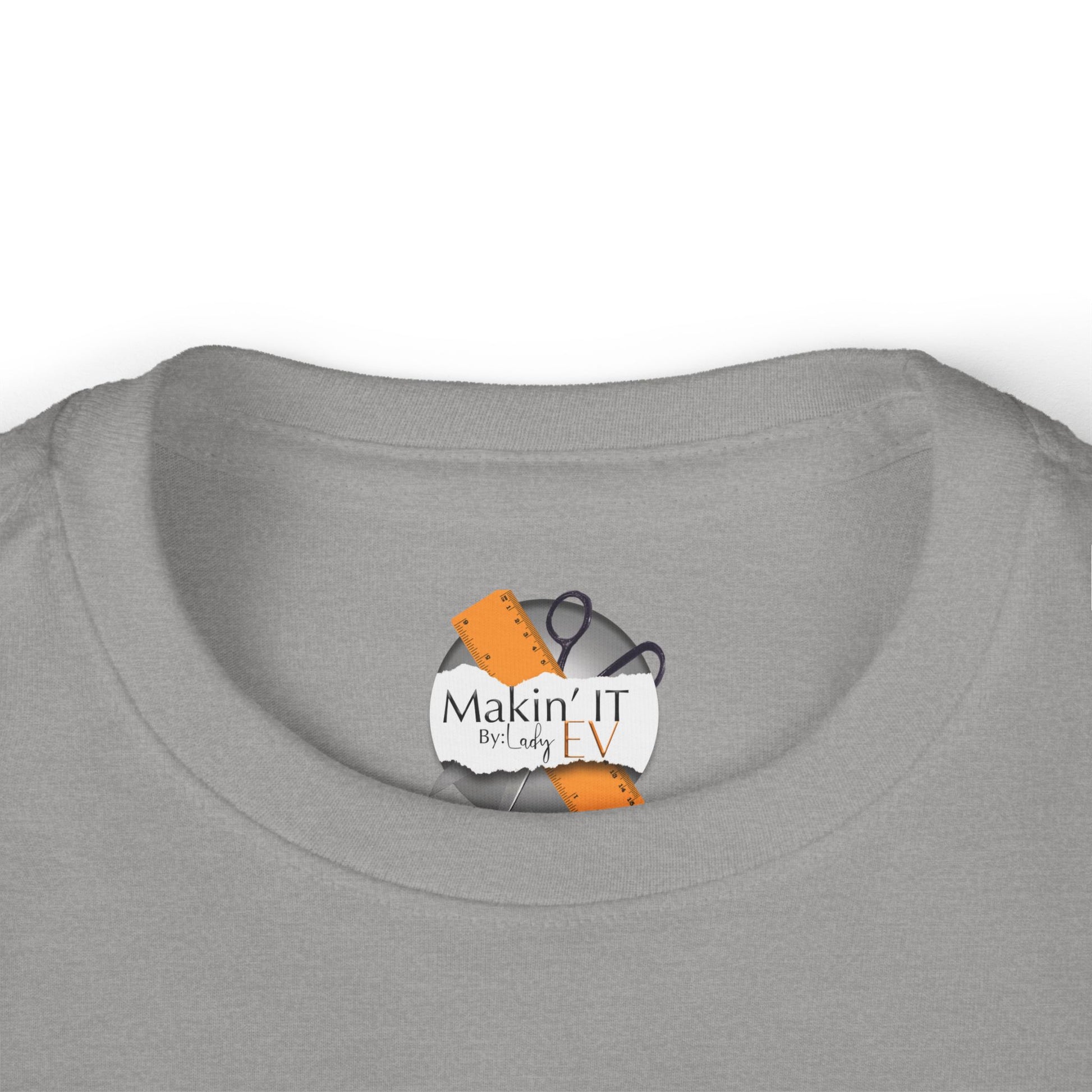Close-up of Makin’ It By Lady Ev neck label on heather gray Stronger Than Sugar toddler shirt — detailed craftsmanship on kids awareness apparel.