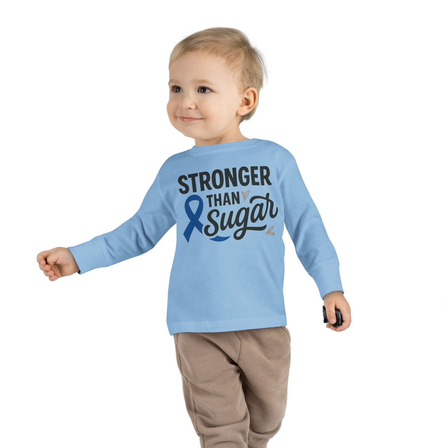 Toddler boy wearing light blue Stronger Than Sugar shirt — cheerful unisex awareness top featuring diabetes blue ribbon design for health advocacy.