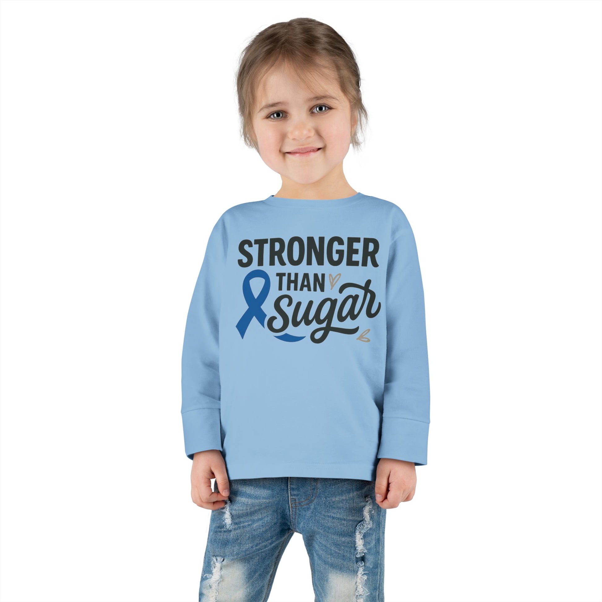Toddler girl in light blue Stronger Than Sugar long sleeve — inspiring kids awareness shirt promoting diabetes advocacy and positive strength.