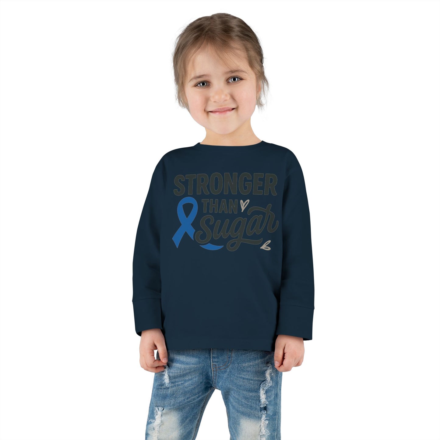 Toddler girl wearing navy Stronger Than Sugar shirt — long sleeve awareness apparel for kids advocating diabetes strength and positivity.