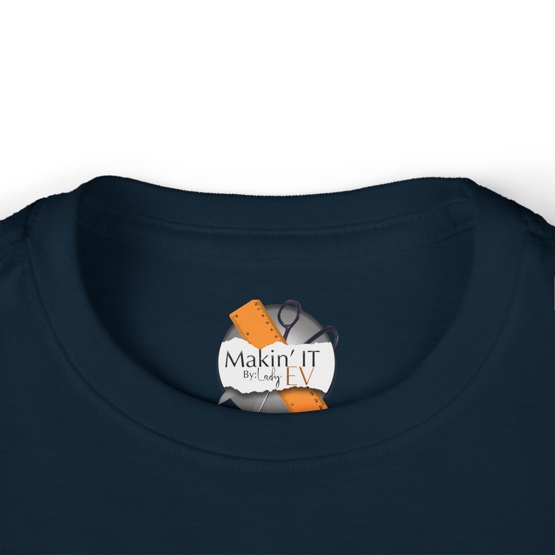 Close-up of Makin’ It By Lady Ev neck tag on navy Stronger Than Sugar toddler long sleeve — quality detail on cozy awareness apparel for children.