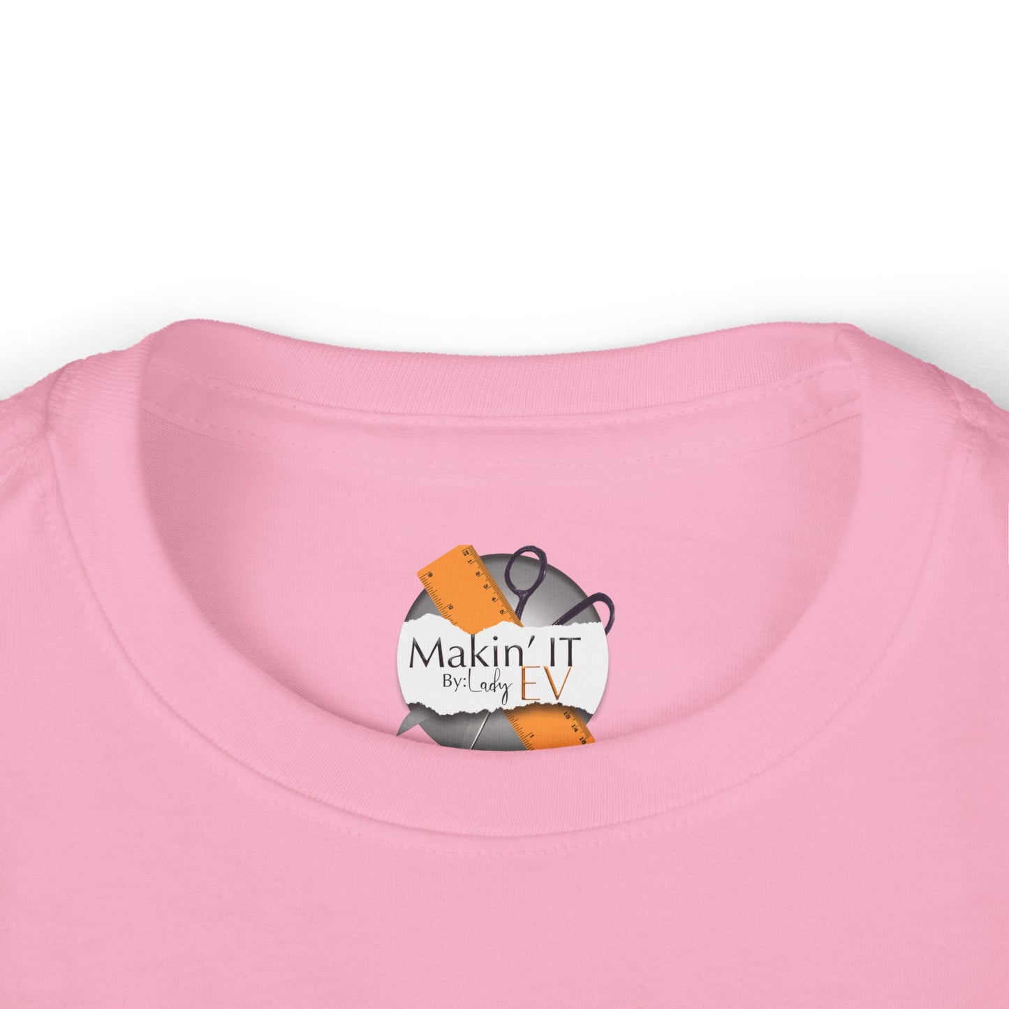 Close-up of Makin’ It By Lady Ev neck label on pink Stronger Than Sugar toddler long sleeve — premium detail on kids awareness apparel.