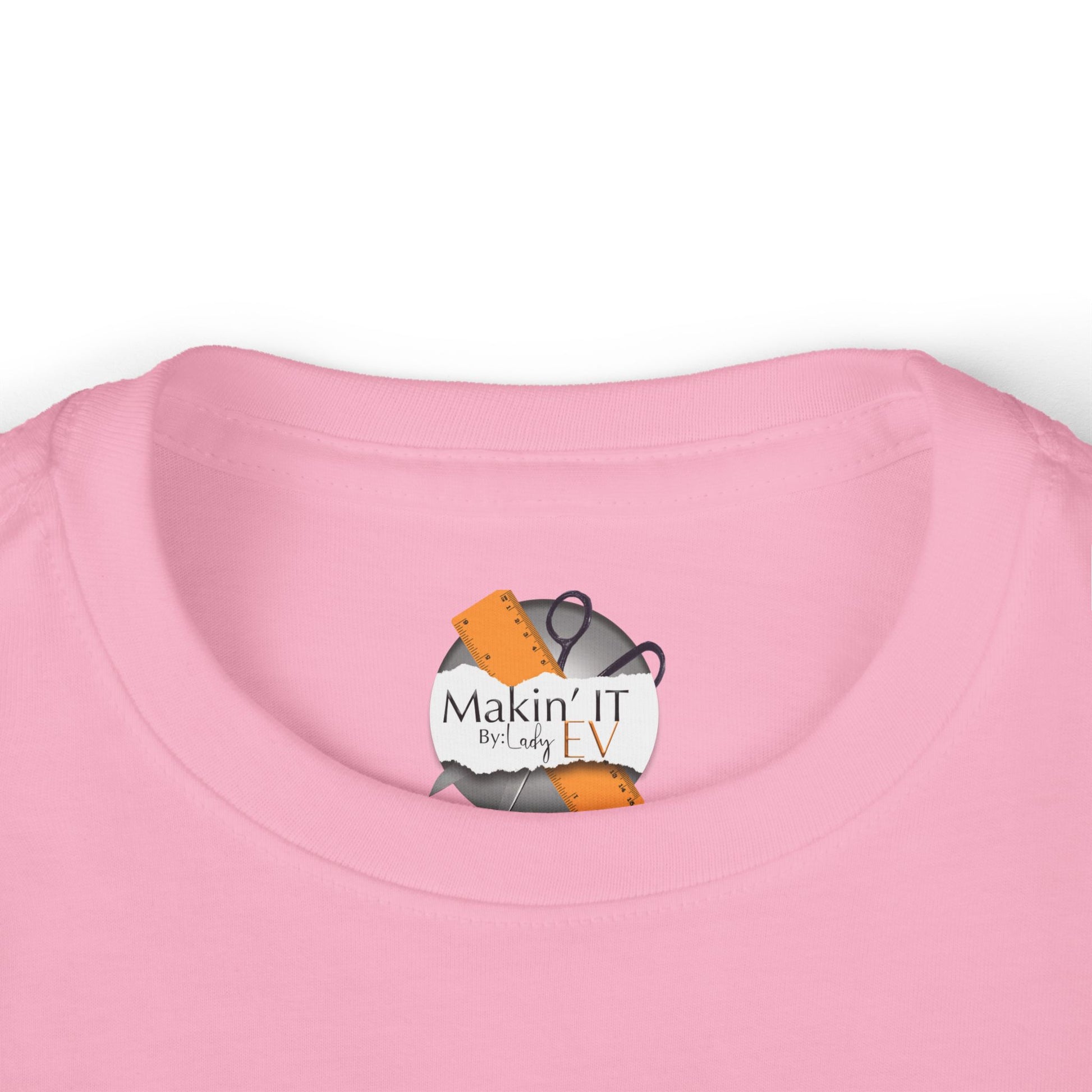 Close-up of Makin’ It By Lady Ev neck label on pink Stronger Than Sugar toddler long sleeve — premium detail on kids awareness apparel.