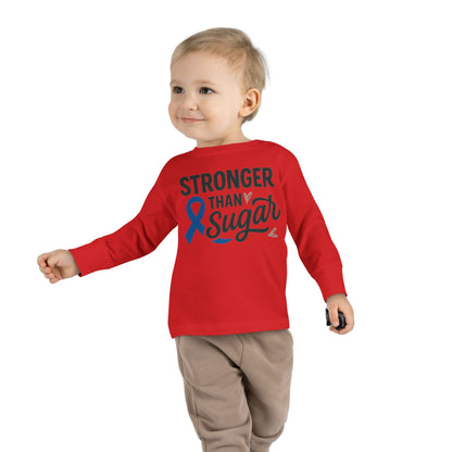 Toddler boy wearing red Stronger Than Sugar long sleeve shirt — comfortable kids awareness tee with blue ribbon supporting diabetes advocacy.
