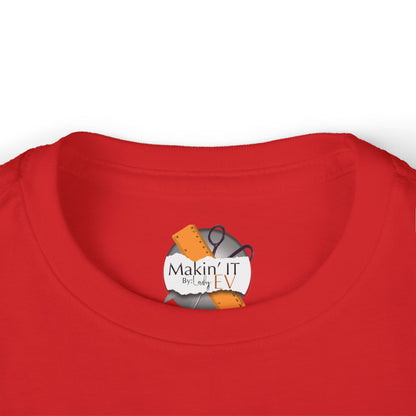 Close-up of Makin’ It By Lady Ev neck label on red Stronger Than Sugar toddler shirt — premium detail highlighting quality and craft.
