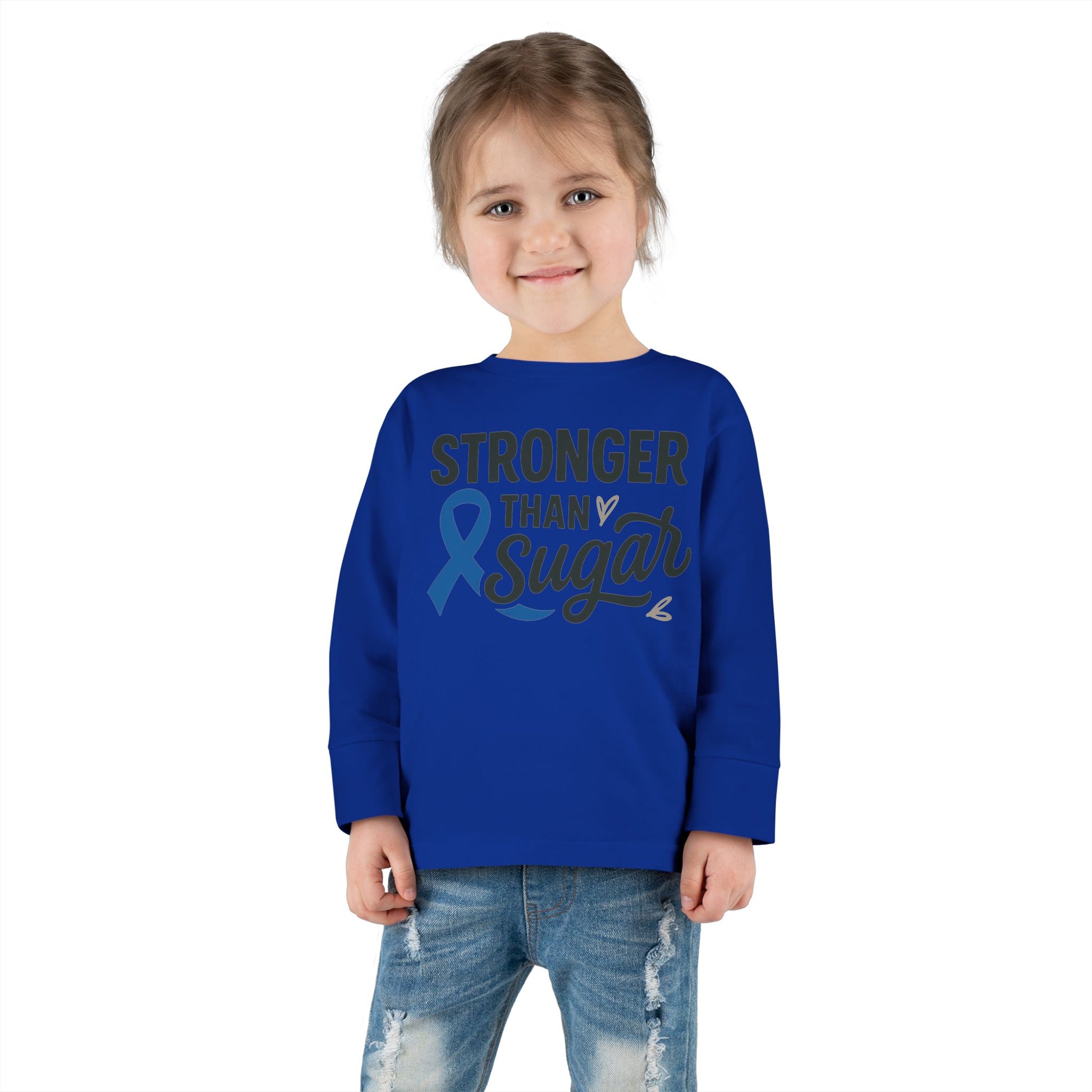 Toddler girl in royal blue Stronger Than Sugar shirt — unisex long sleeve for diabetes awareness, comfort, and motivation by Makin’ It By Lady Ev.