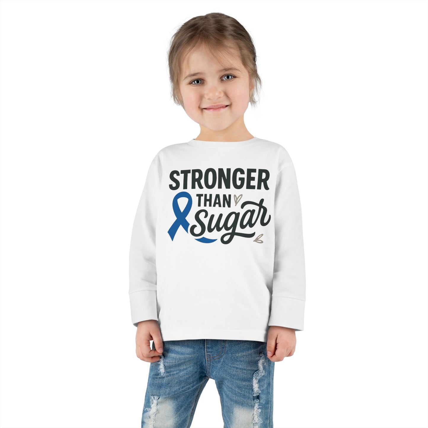 Toddler girl in white Stronger Than Sugar long sleeve shirt — unisex children’s awareness tee encouraging strength and support for diabetes advocacy.