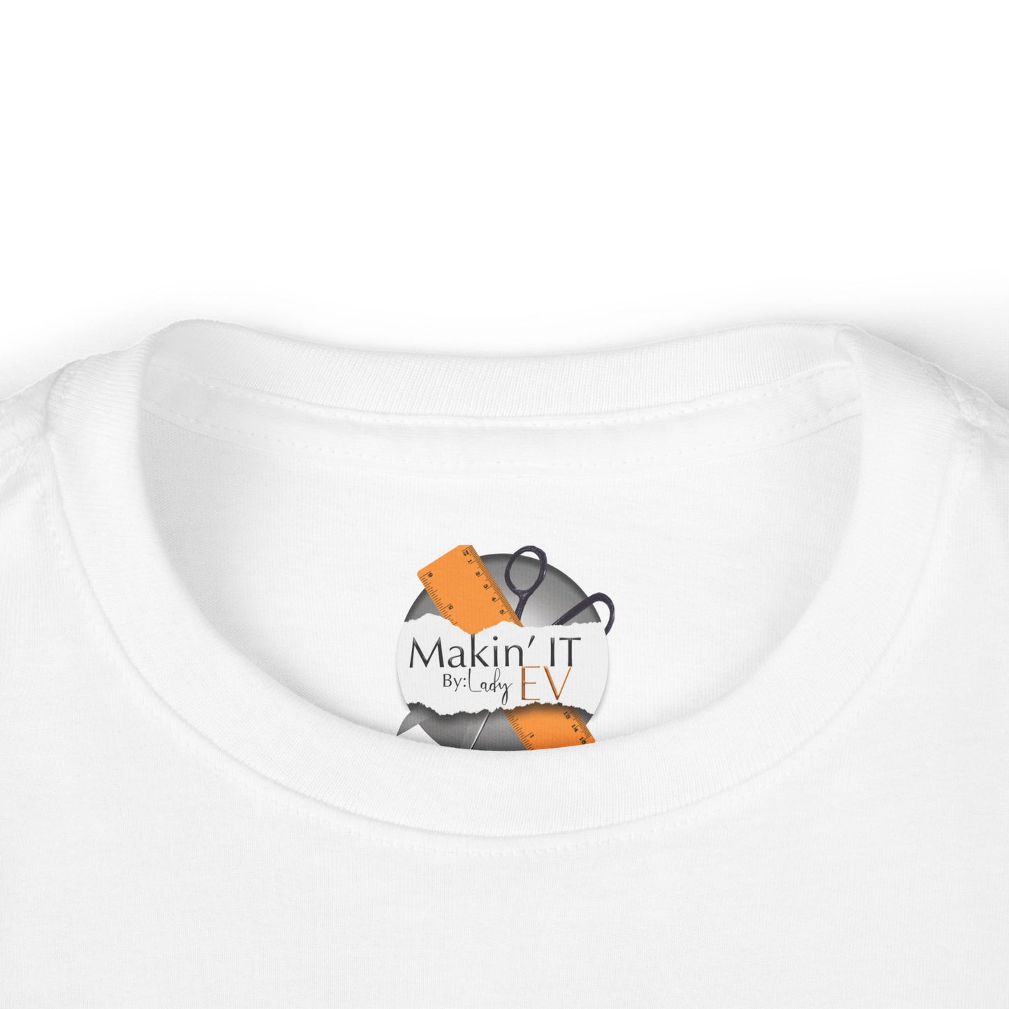 Close-up of Makin’ It By Lady Ev neck label on white Stronger Than Sugar toddler shirt — premium detail on high-quality kids awareness apparel.