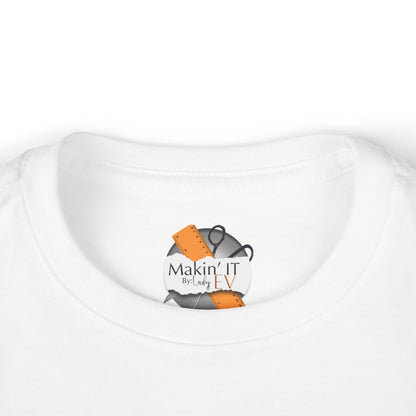 Close-up of Makin’ It By Lady Ev neck label on white Stronger Than Sugar toddler shirt — premium detail on high-quality kids awareness apparel.