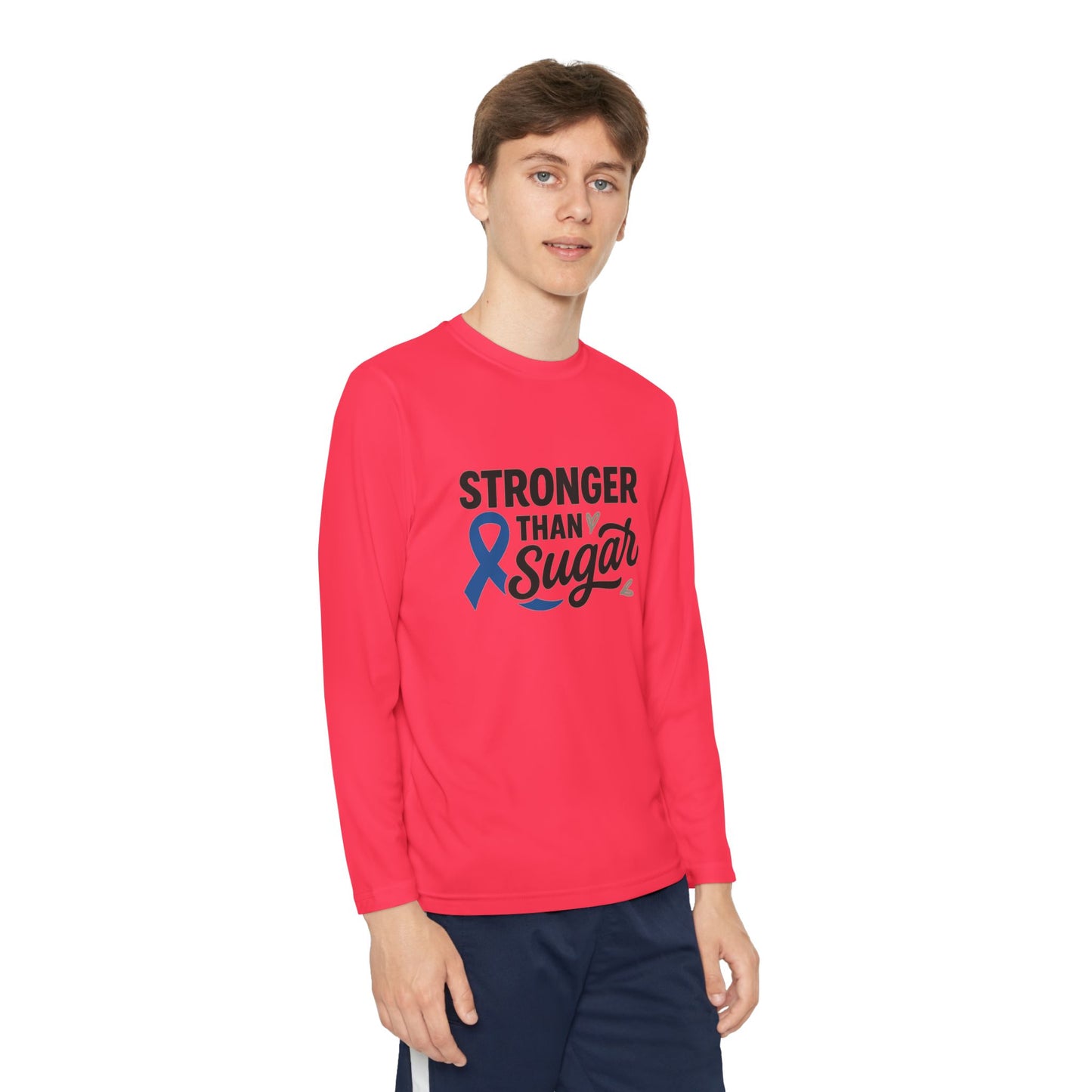 Youth boy in hot coral Stronger Than Sugar long sleeve shirt — bright unisex awareness top with blue diabetes ribbon for empowerment and courage.