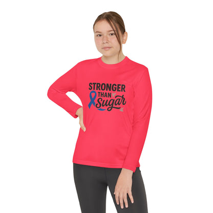 Youth girl wearing hot coral Stronger Than Sugar long sleeve — motivational awareness tee promoting diabetes advocacy, strength, and hope.