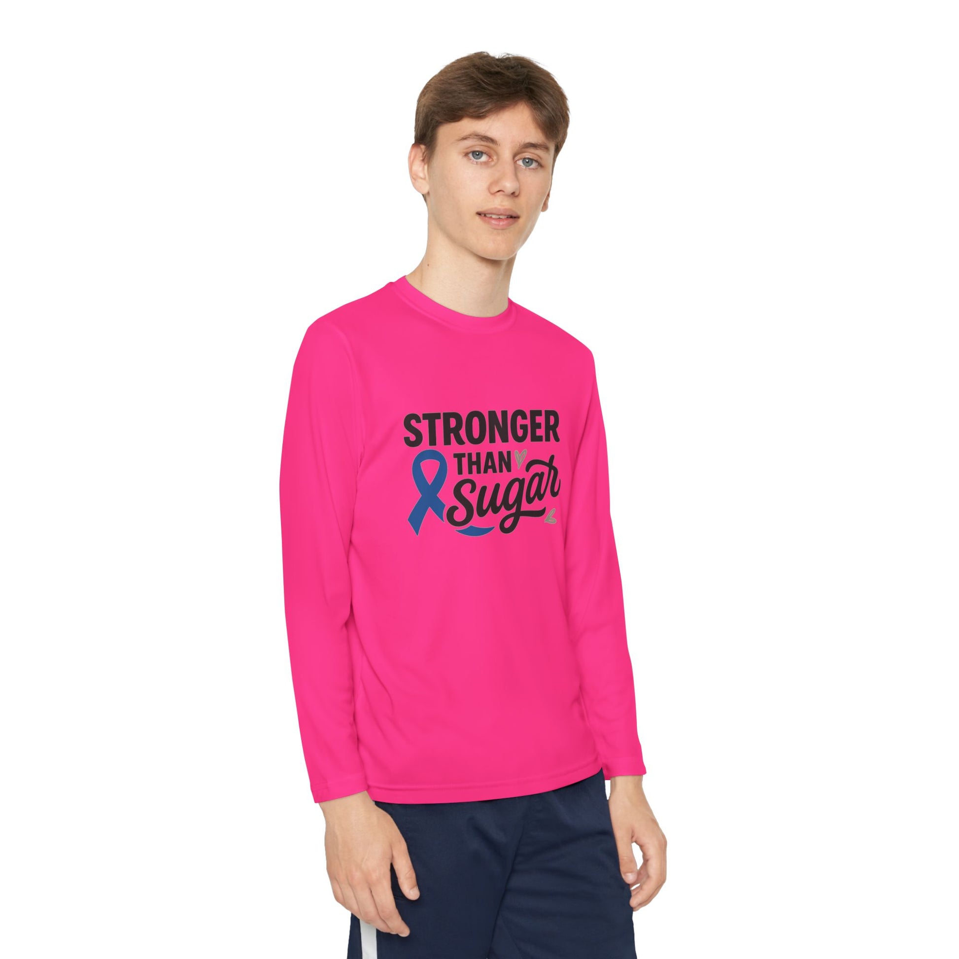Youth boy in neon pink Stronger Than Sugar shirt — bright awareness long sleeve for kids featuring blue diabetes ribbon for health advocacy.