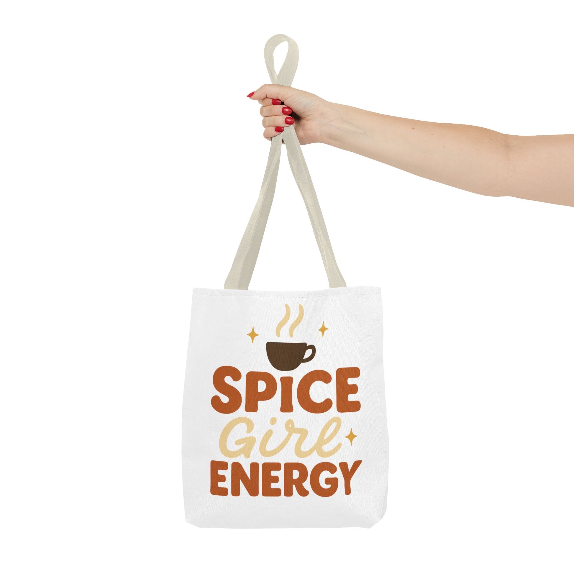 Beige-handled white “Spice Girl Energy” tote bag held in hand — stylish fall tote for coffee lovers and everyday use.
