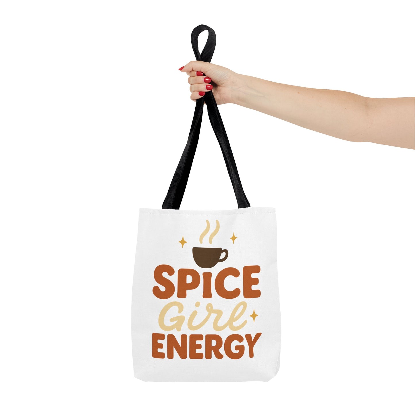 White “Spice Girl Energy” tote bag with black handles held by hand — stylish autumn tote for coffee lovers and everyday errands.