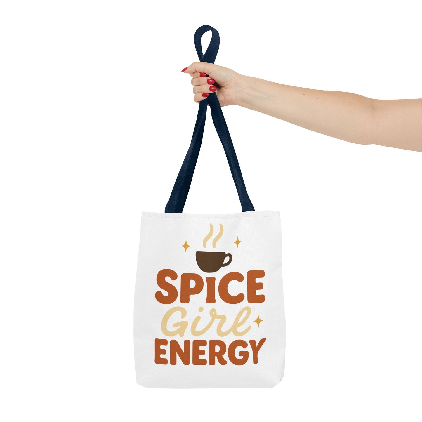 Navy-handled white “Spice Girl Energy” tote bag held in hand — warm-toned coffee aesthetic tote for fall fashion lovers.