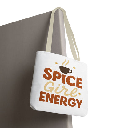 White “Spice Girl Energy” tote bag with beige straps hanging on wall — minimalist autumn tote featuring coffee cup design and retro charm.