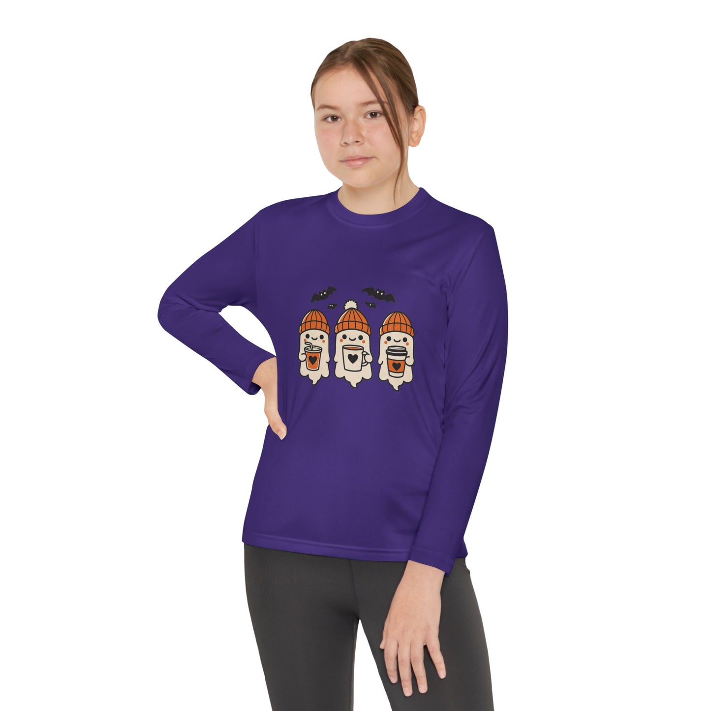 Young Female model in purple long sleeve shirt featuring three smiling Halloween ghosts in orange beanies holding coffee mugs with bats above, Makin’ It By Lady Ev design.