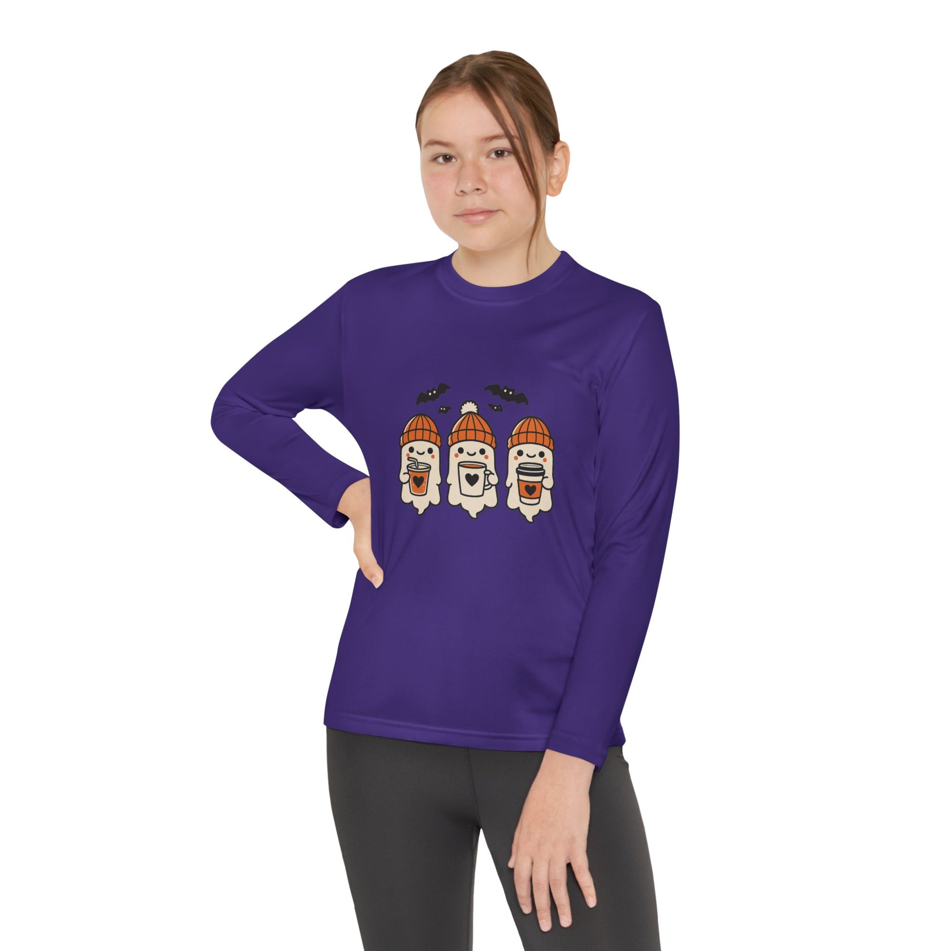 Young Female model in purple long sleeve shirt featuring three smiling Halloween ghosts in orange beanies holding coffee mugs with bats above, Makin’ It By Lady Ev design.