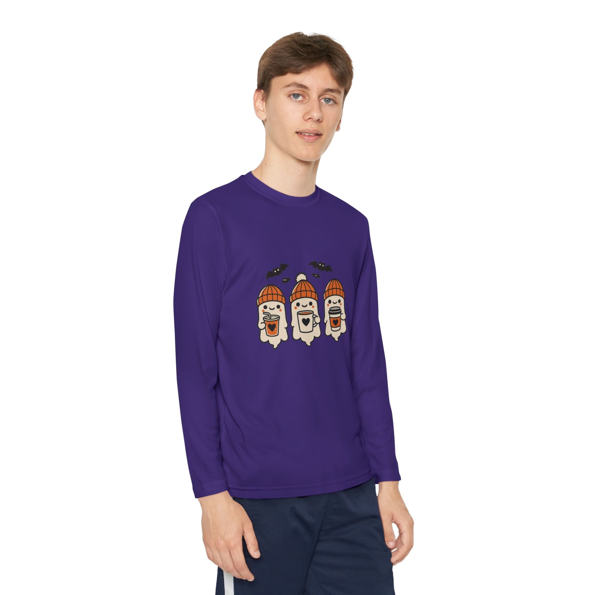 Young Male model wearing purple long sleeve Halloween shirt with three cozy ghosts in orange beanies holding coffee cups and bats above, by Makin’ It By Lady Ev.